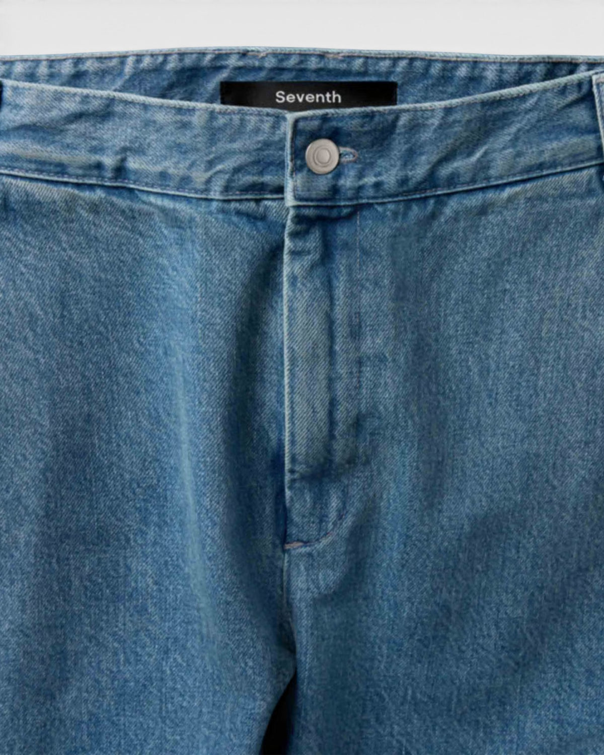 Lockwood Avenue Seventh V10 denim Bermuda jeans featuring a faded vintage wash, front button closure, and label tag.