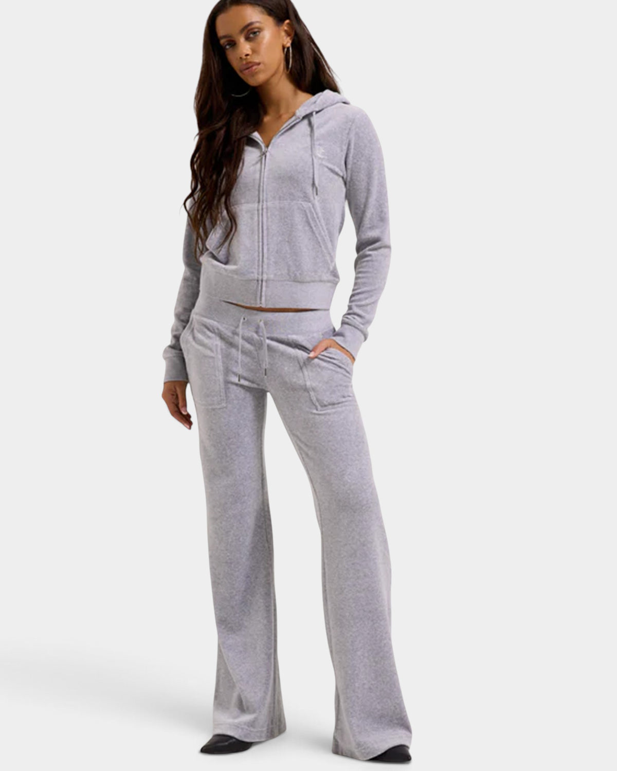 Lockwood Avenue model wearing silver marl velour flared joggers and matching zip-up hoodie with JC logo embroidery