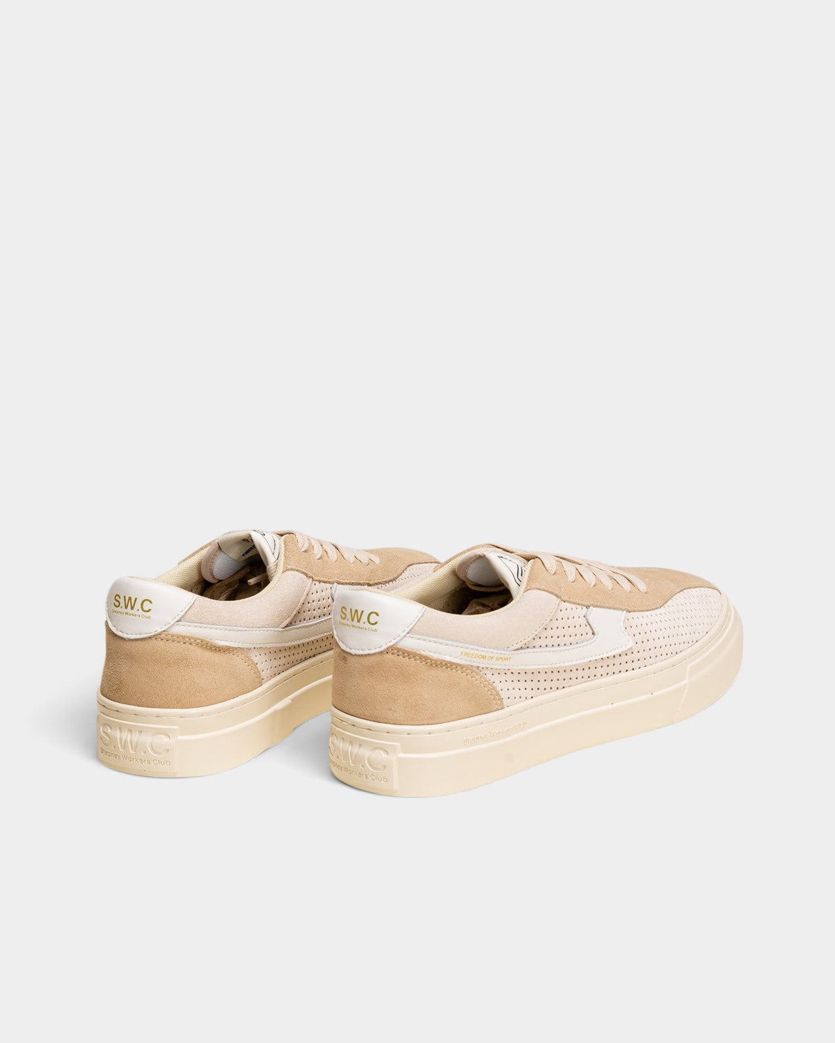Lockwood Avenue Stepney Workers Club Dellow S-Strike sneakers in ecru and beige perforated suede with white accents.