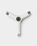 Lockwood Avenue white Y-shaped skateboard tool with three fixed metal sockets for kingpin, axle, and mounting nuts.