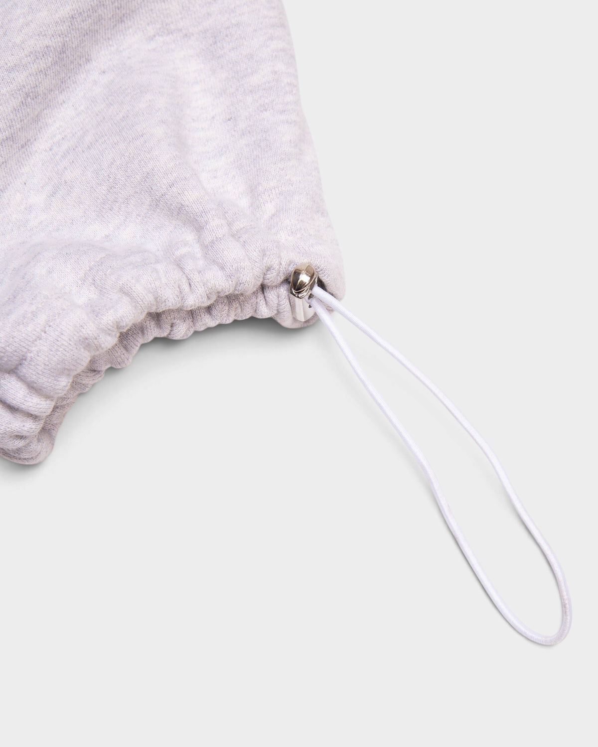 Detail of the elasticated cuff with a white bungee cord and silver toggle on the heather grey Lockwood Small Embroidered Logo Sweatpants