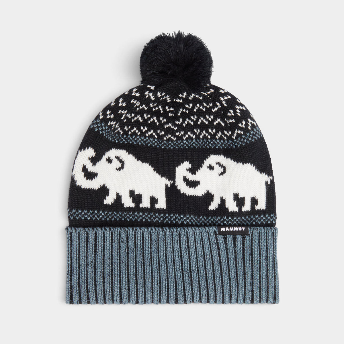 Mammut Retro Beanie in Black-Strata, a black pom-pom beanie with white mammoths knitted in a band around the body, a flecked black and white crown and a ribbed blue-grey cuff with a small woven MAMMUT label