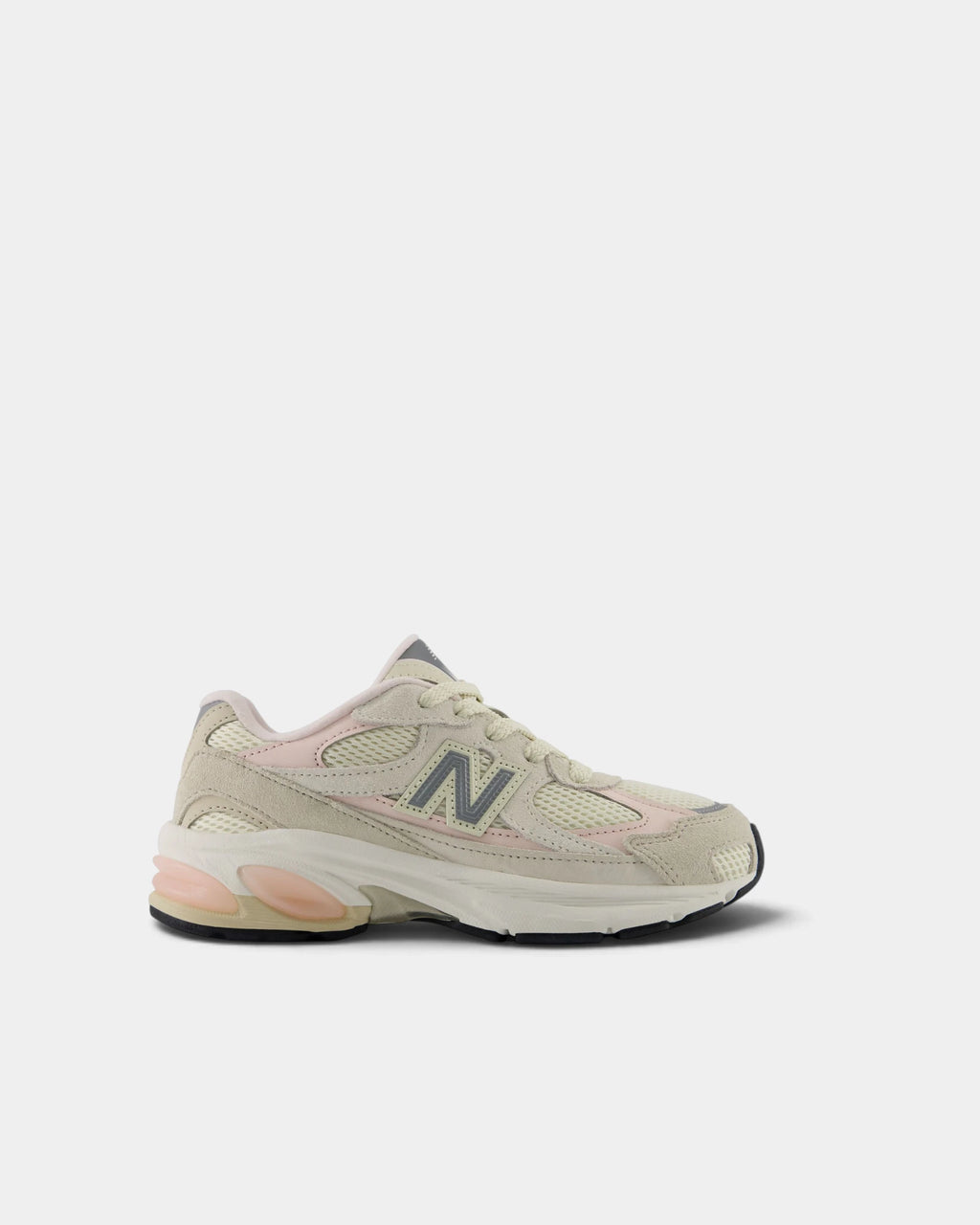 Lockwood Avenue New Balance 2010 kids shoe in turtledove suede and cream mesh, side view showing the grey N, shell pink panels and the peach ABZORB pods in the midsole