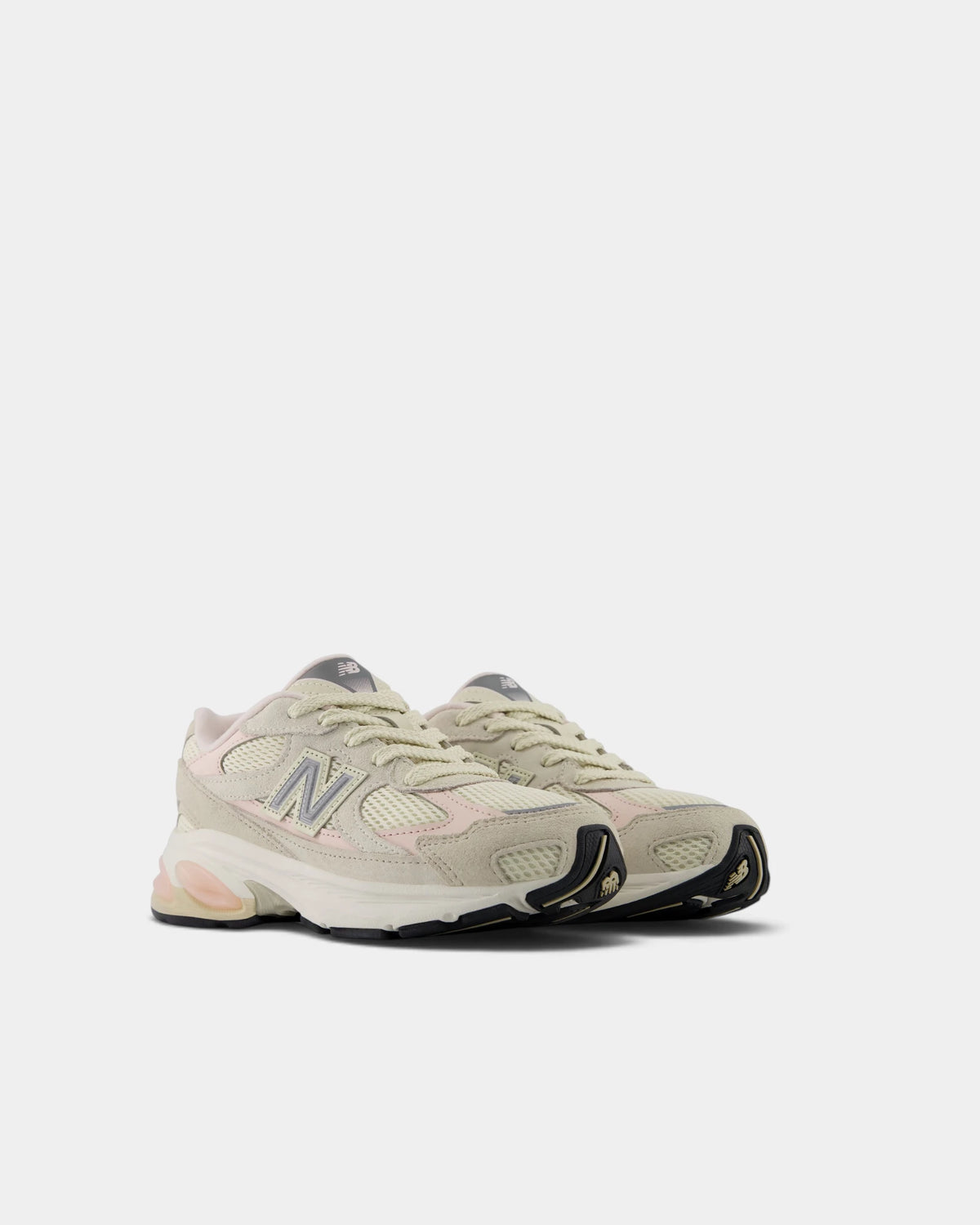 Lockwood Avenue New Balance 2010 kids shoes in turtledove and shell pink, angled front view of the pair with the layered suede toe and chunky white midsole