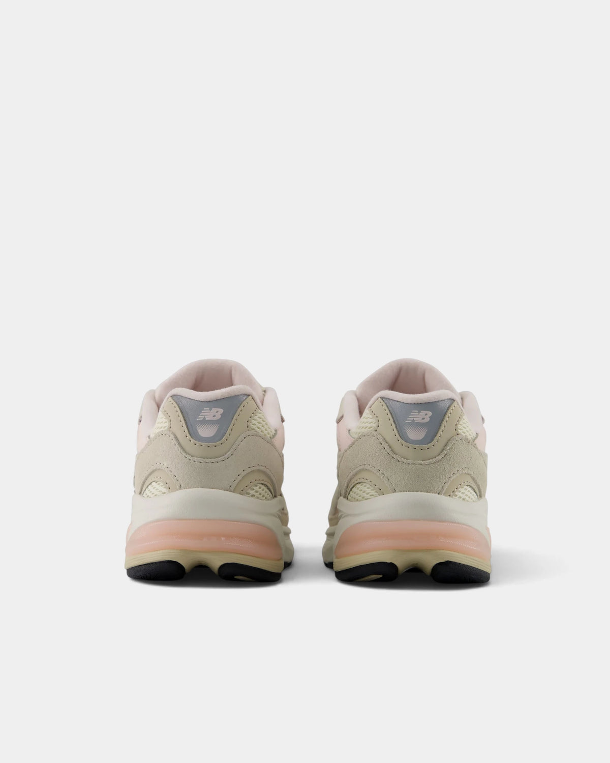 Lockwood Avenue New Balance 2010 kids shoes in turtledove, rear view of the pair showing the grey NB heel tabs and peach heel pods