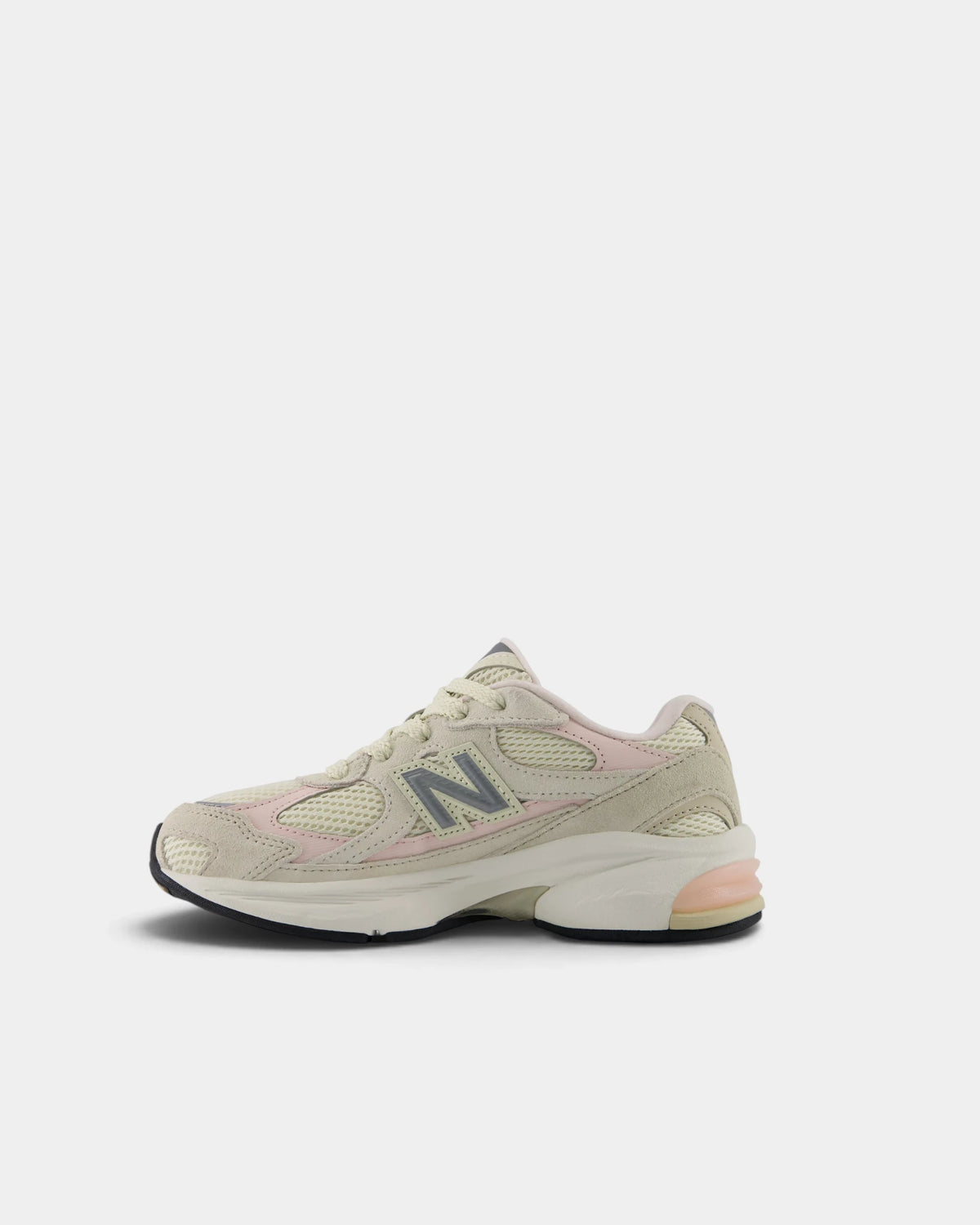 Lockwood Avenue New Balance 2010 kids shoe in turtledove and shell pink, angled view from the inner side with the grey N and pink mesh underlay