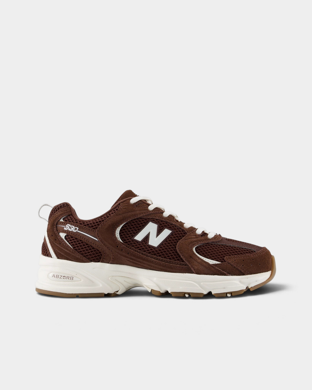 New Balance 530 Shoes in Pumpernickel/Sea Salt, side profile: dark brown suede and mesh upper with a white N logo, cream laces and a white midsole over a gum outsole