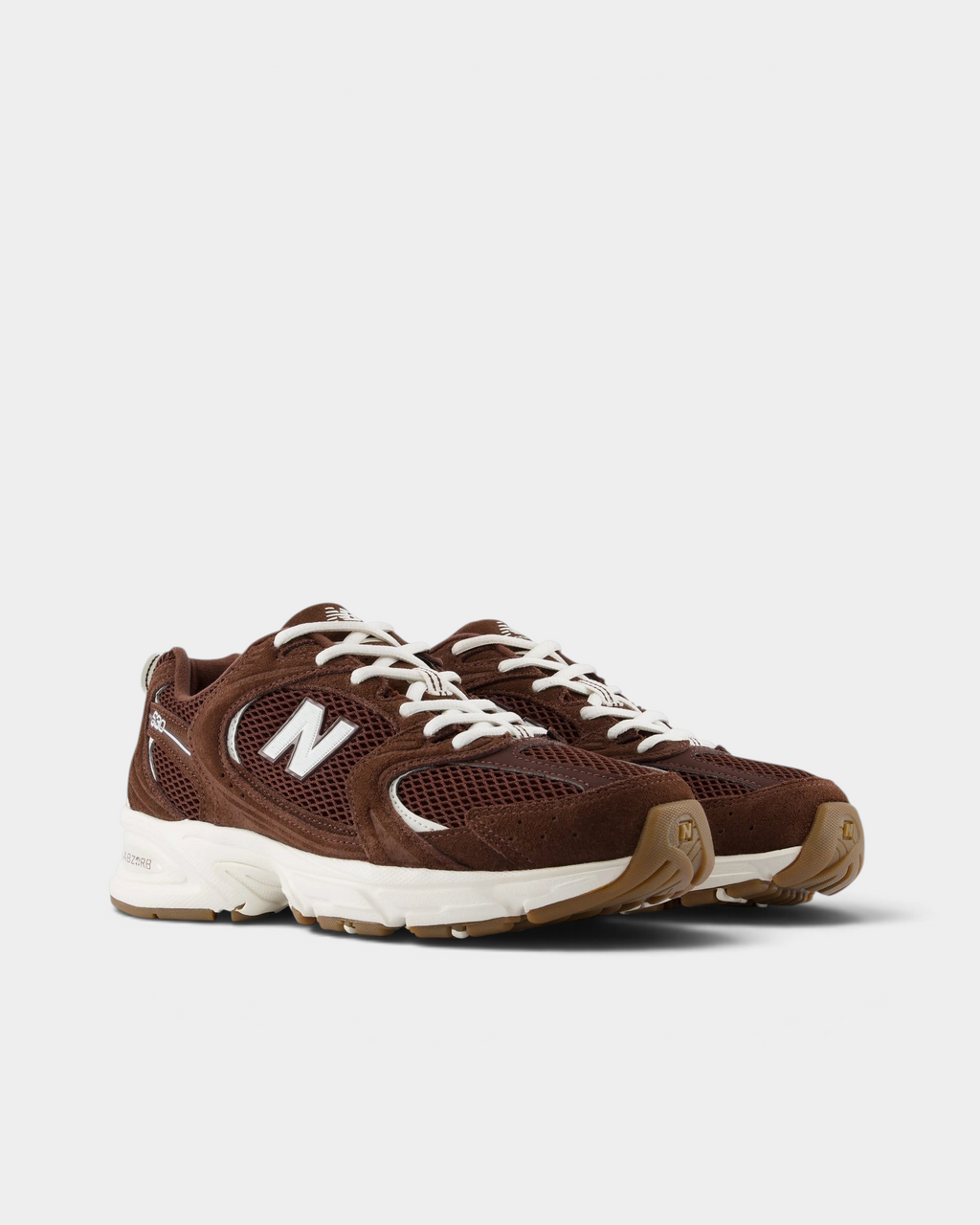 New Balance 530 Shoes in Pumpernickel/Sea Salt, pair at a three-quarter front angle showing the brown mesh toe box, white N logos and cream laces