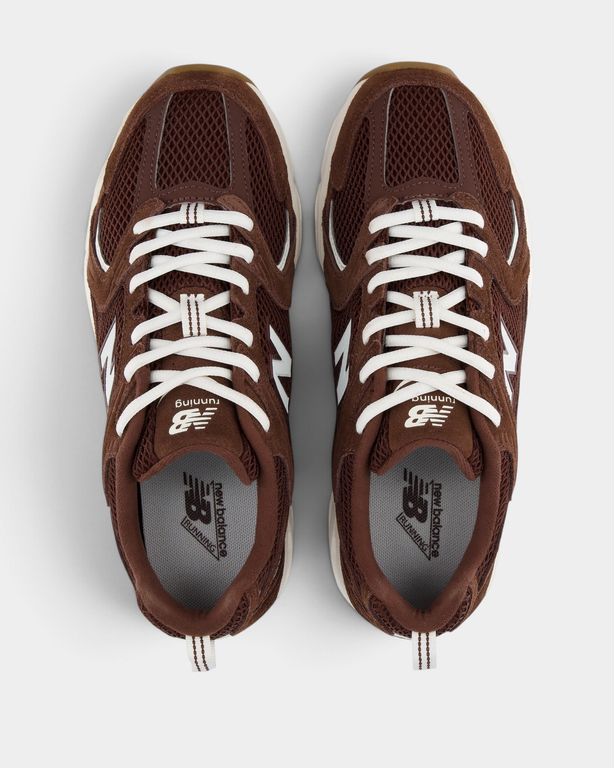 New Balance 530 Shoes in Pumpernickel/Sea Salt, pair from above with cream laces over a dark brown mesh upper, grey insoles and the white New Balance tongue label