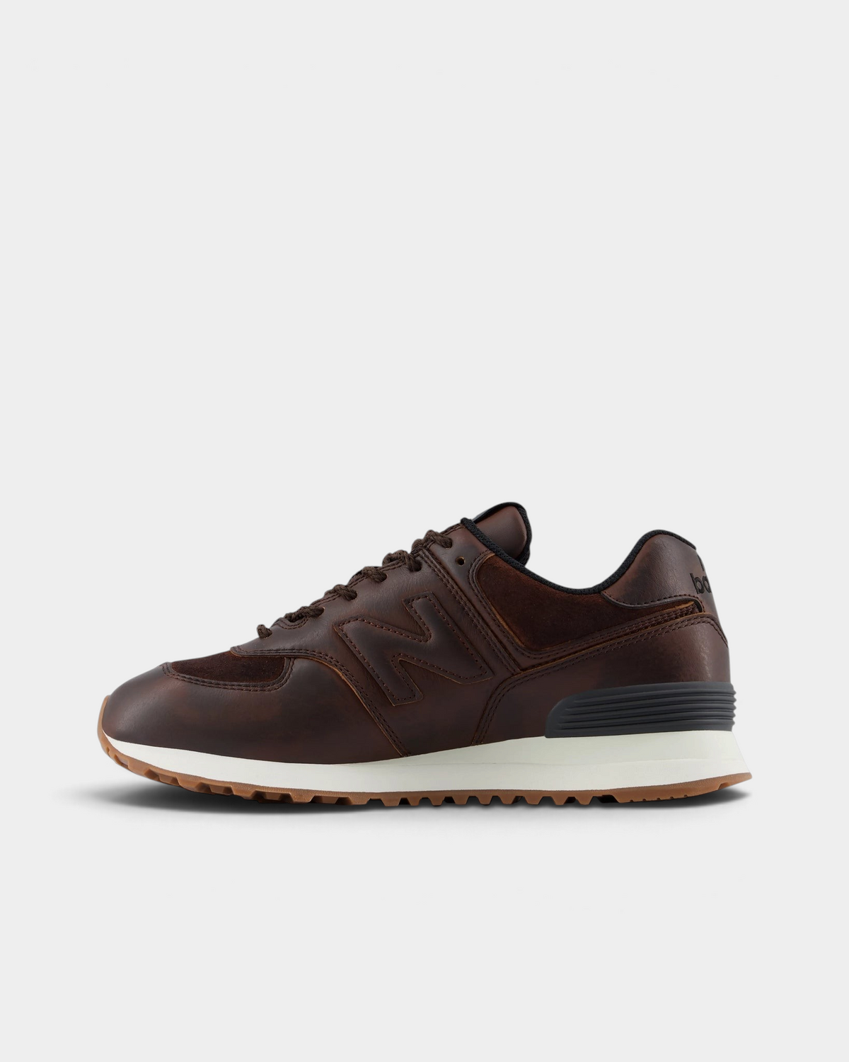 New Balance 574 Shoes in Pumpernickel/Sea Salt, pair from the inner side: brown leather and suede panels with a tonal N logo and a cream midsole
