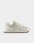 New Balance 574 Shoes in Sea Salt/Breakfast Tea, side profile: washed cream leather upper with tonal N logo, tan stitched edges and a gum outsole