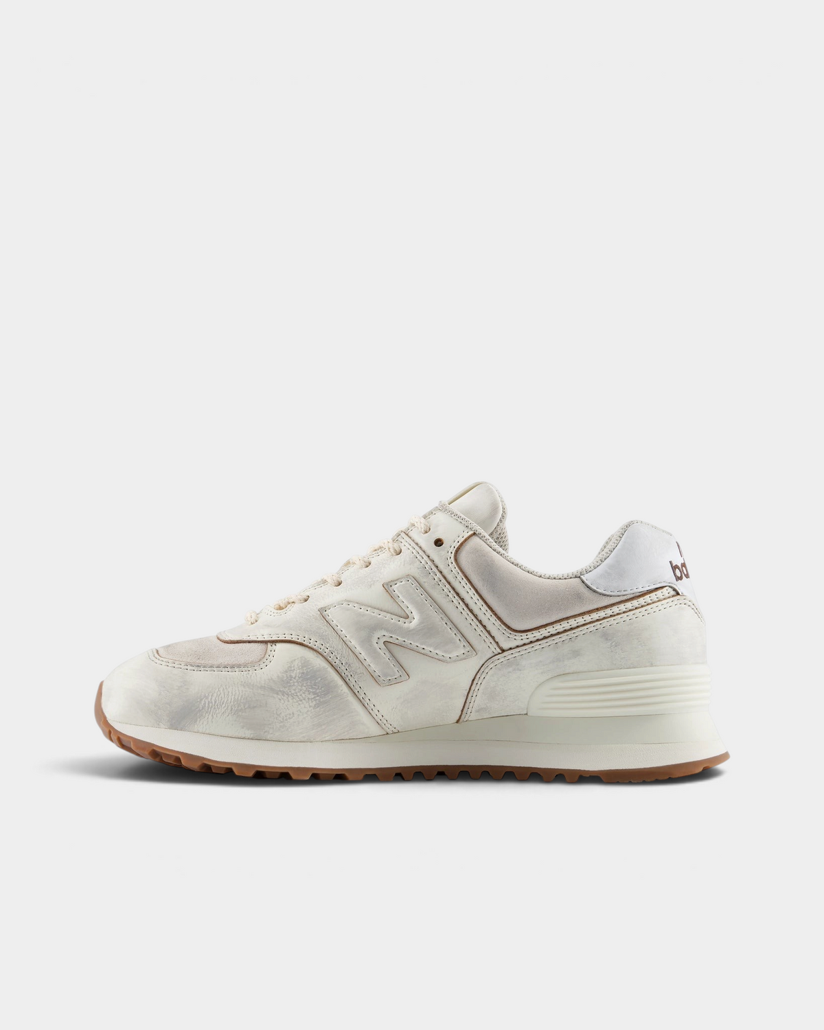 New Balance 574 Shoes in Sea Salt/Breakfast Tea, pair from the inner side: cream suede and leather panels with a tonal N logo and a tan rubber edge
