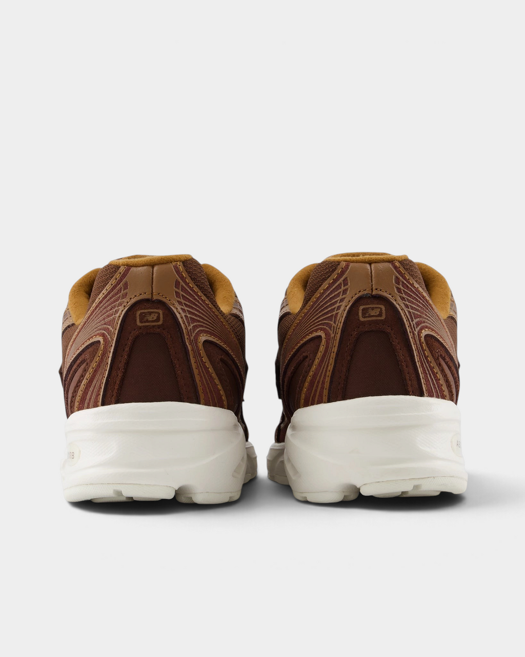 New Balance 740v2 Shoes in Pumpernickel/Sea Salt, pair from behind: brown heel panels with caramel collars over a thick cream midsole
