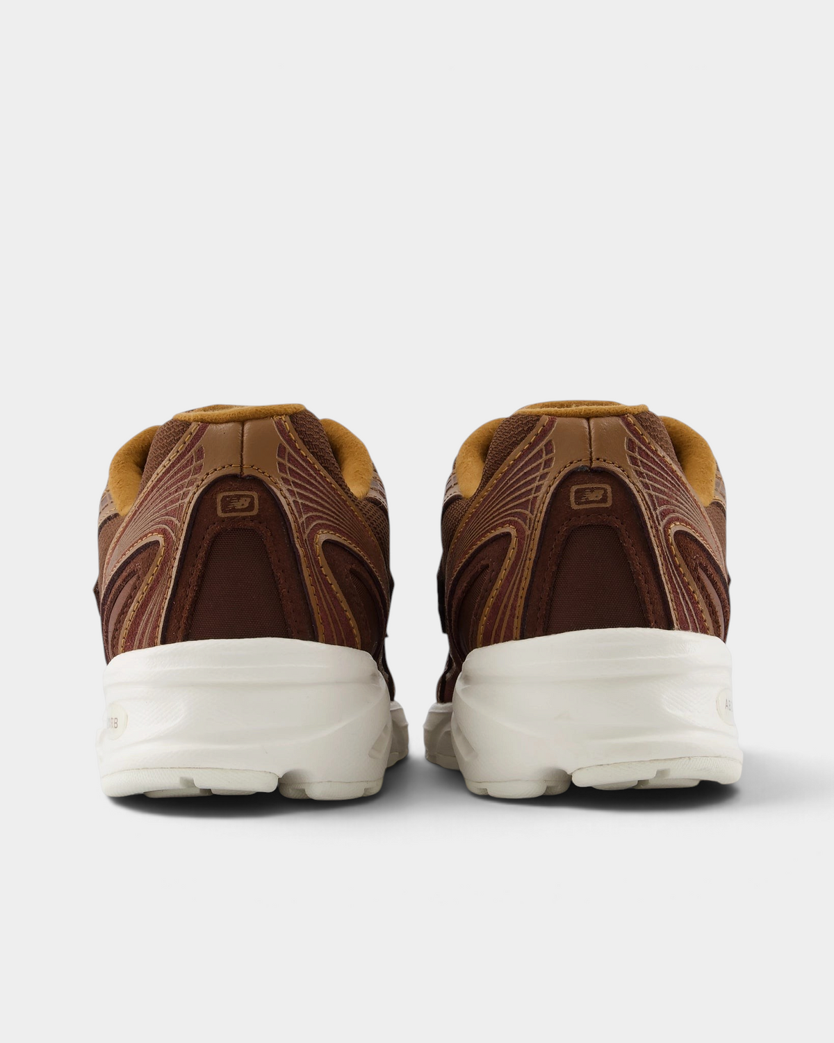 New Balance 740v2 Shoes in Pumpernickel/Sea Salt, pair from behind: brown heel panels with caramel collars over a thick cream midsole