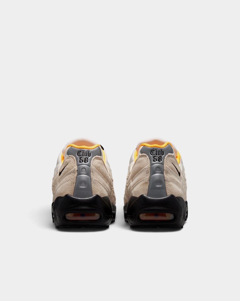 Rear view of Lockwood Avenue Nike SB Air Max 95 Club 58 sneakers in sail, black, and laser orange suede and mesh.
