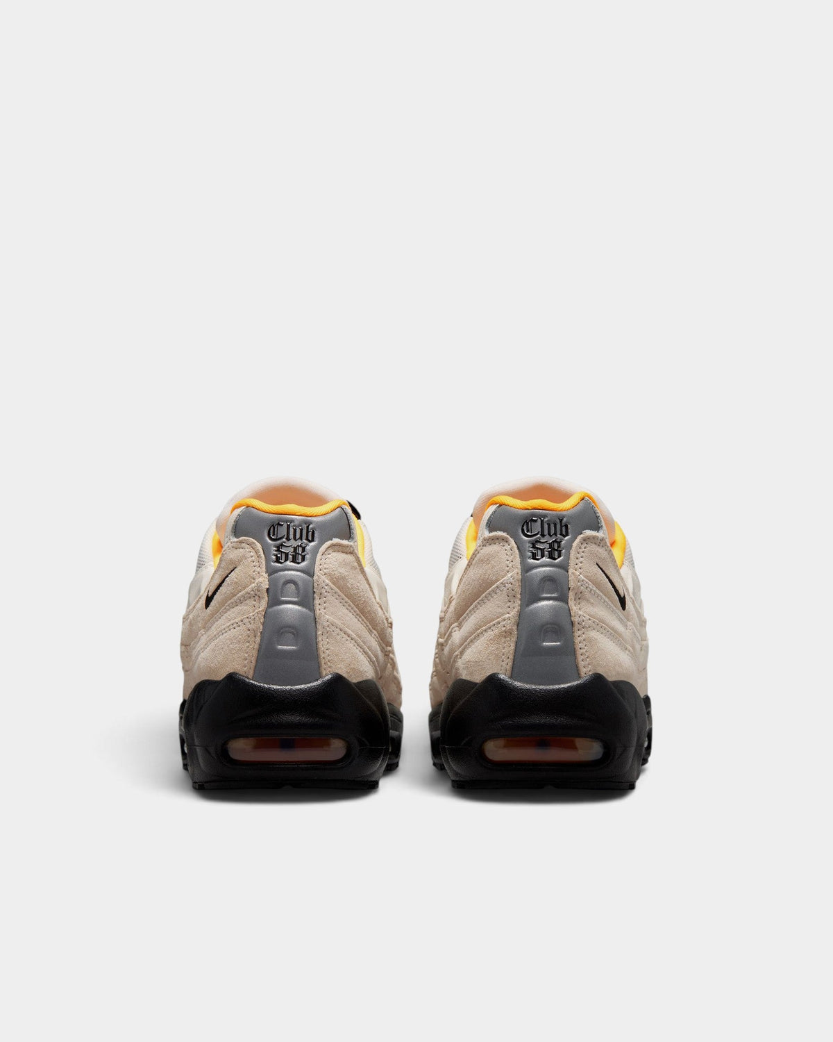 Rear view of Lockwood Avenue Nike SB Air Max 95 Club 58 sneakers in sail, black, and laser orange suede and mesh.