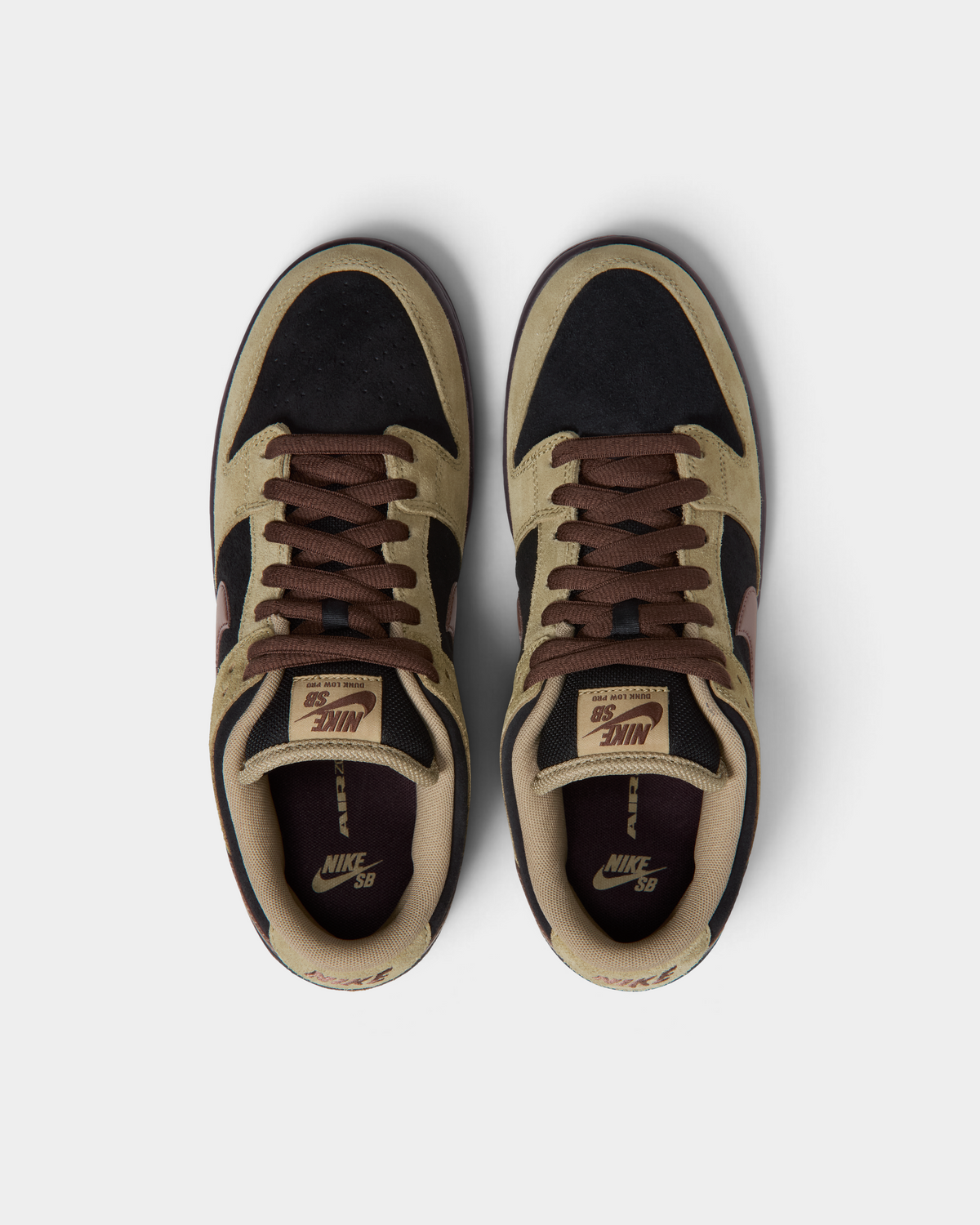 Nike SB Dunk Low Pro Shoes in Filbert/Light Chocolate/Black/Burgundy Ash, the pair from above with the toes pointing up: brown laces, tan and black suede, SB tongue labels and the Air Zoom insoles