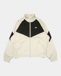 Nike SB Pavan Jacket in light orewood brown and black, flat-lay front view with the black chevron panel across the chest and the Nike SB logo