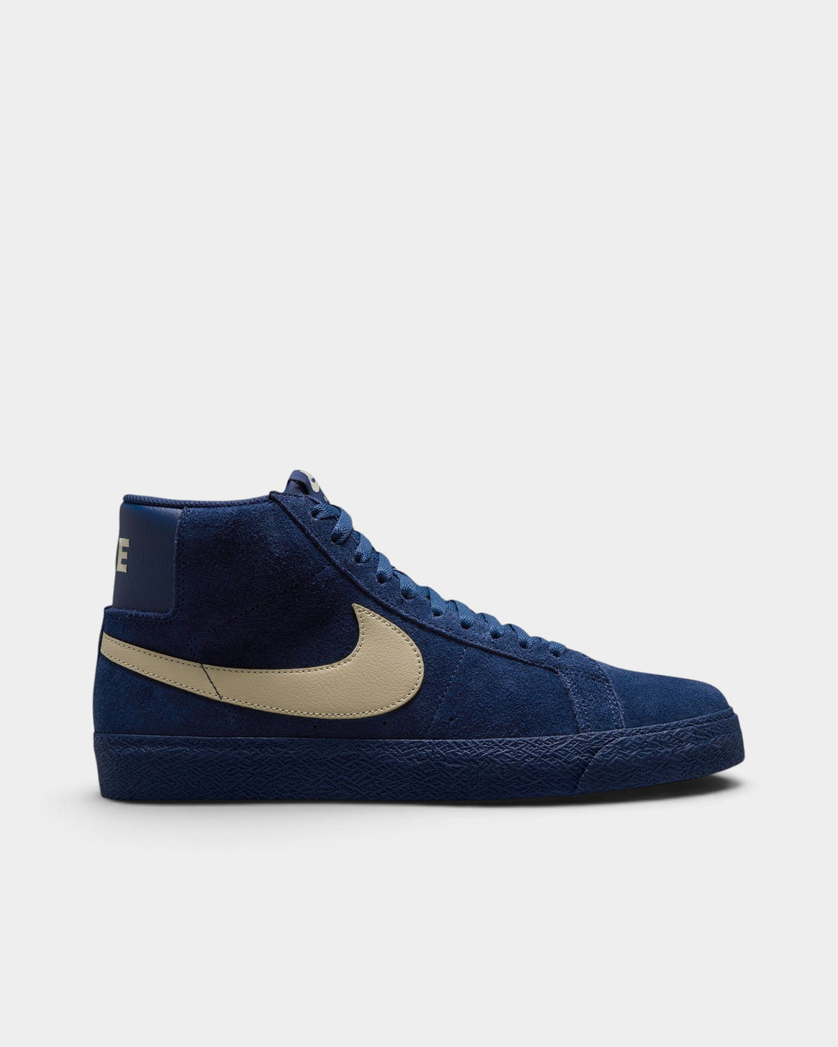 Lockwood Avenue Nike SB Zoom Blazer Mid skate shoes in navy blue suede with a tan leather swoosh side profile