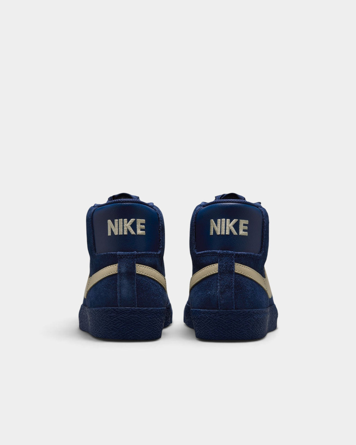 Lockwood Avenue Nike SB Zoom Blazer Mid shoes in navy blue suede with tan swoosh seen from the back