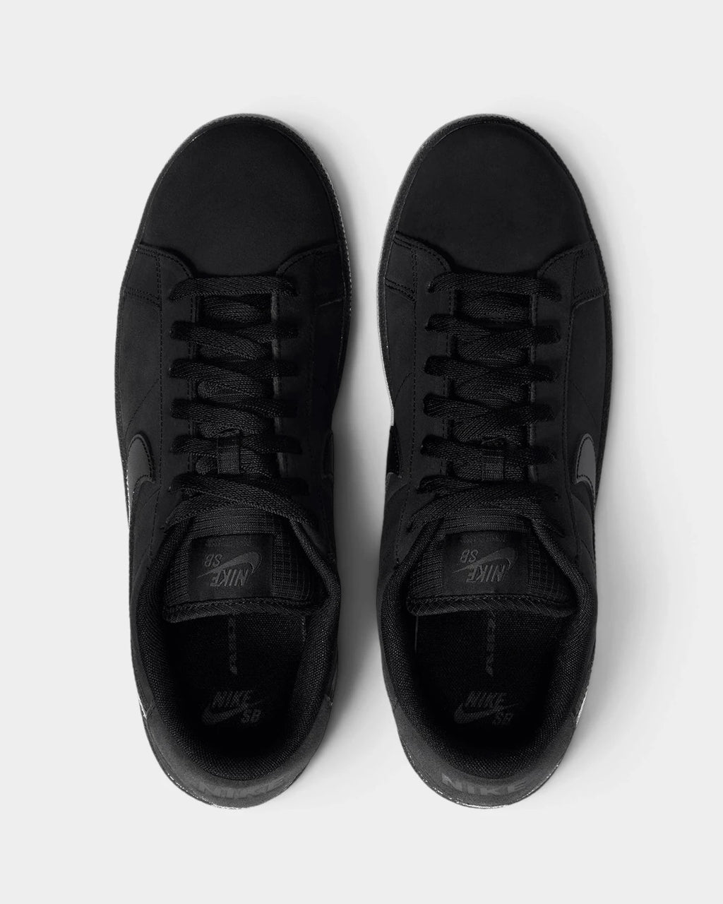 Nike SB Zoom Tennis Classic Shoes in Black/Black/Black/Off Noir, both shoes from above, toes up, showing the black laces and the tonal Nike SB tongue label