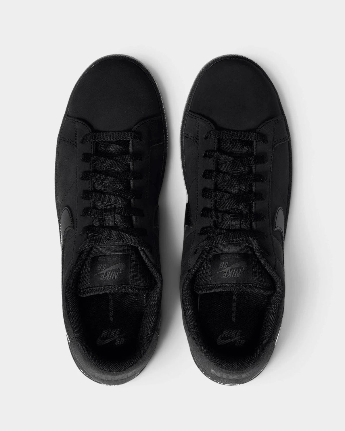 Nike SB Zoom Tennis Classic Shoes in Black/Black/Black/Off Noir, both shoes from above, toes up, showing the black laces and the tonal Nike SB tongue label