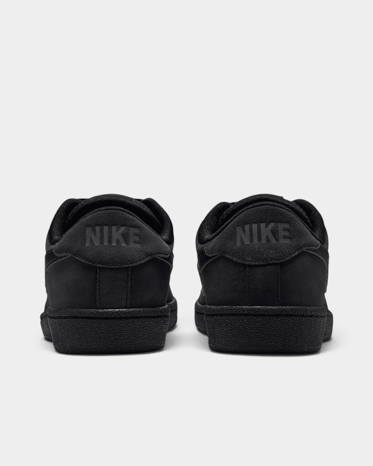 Nike SB Zoom Tennis Classic Shoes in Black/Black/Black/Off Noir, both shoes from behind, showing the tonal NIKE lettering on the heel tabs
