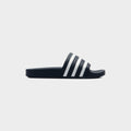 Lockwood Avenue adidas Adilette Slide in AdiBlu navy with white 3-Stripes across the strap, side view