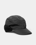 Lockwood Avenue Poetic Collective Ear Flap Cap in black, side view of the nylon cap with the ear flap folded down and the rubber logo patch on the front panel