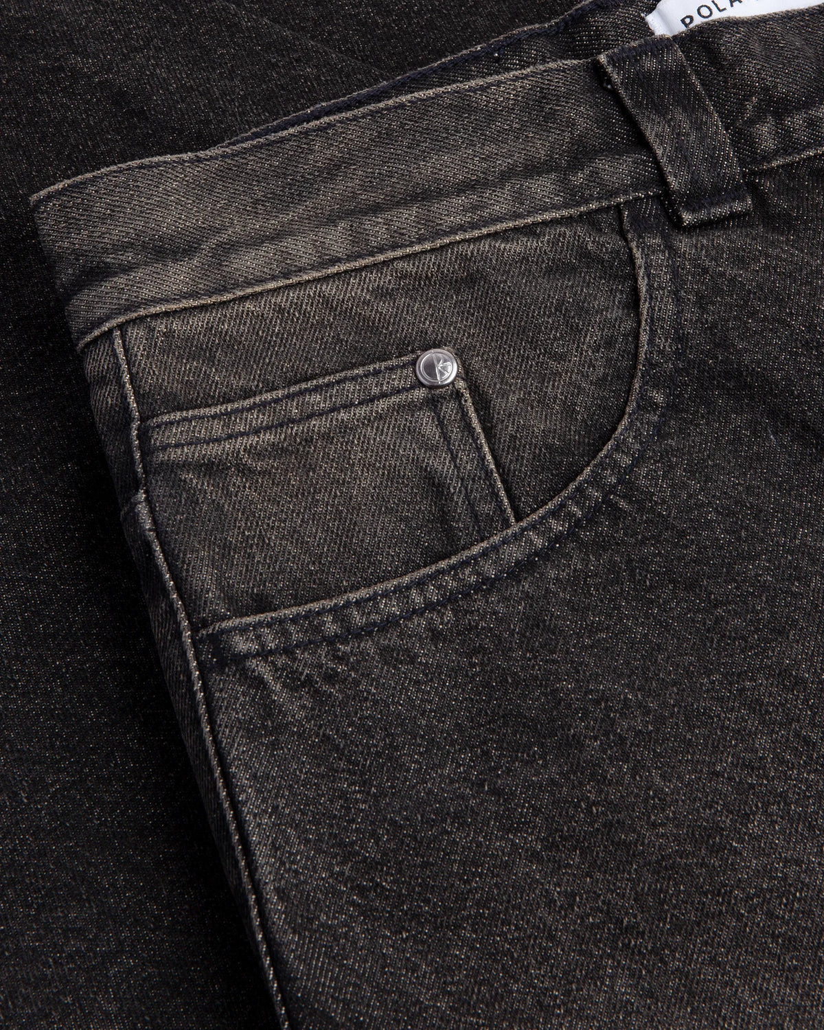 Lockwood Avenue Polar Big Boy Pants in Dirty Black, close up of the front pocket, the coin pocket and the branded shank button