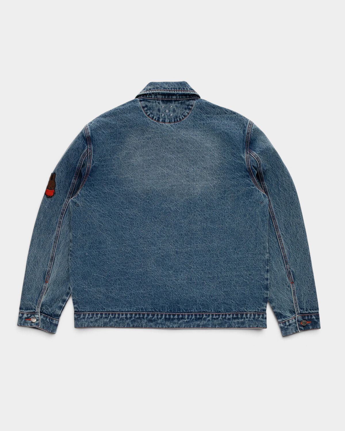 Pop Trading Company x Miffy full button denim jacket in stonewashed blue, back, with a small patch on the sleeve