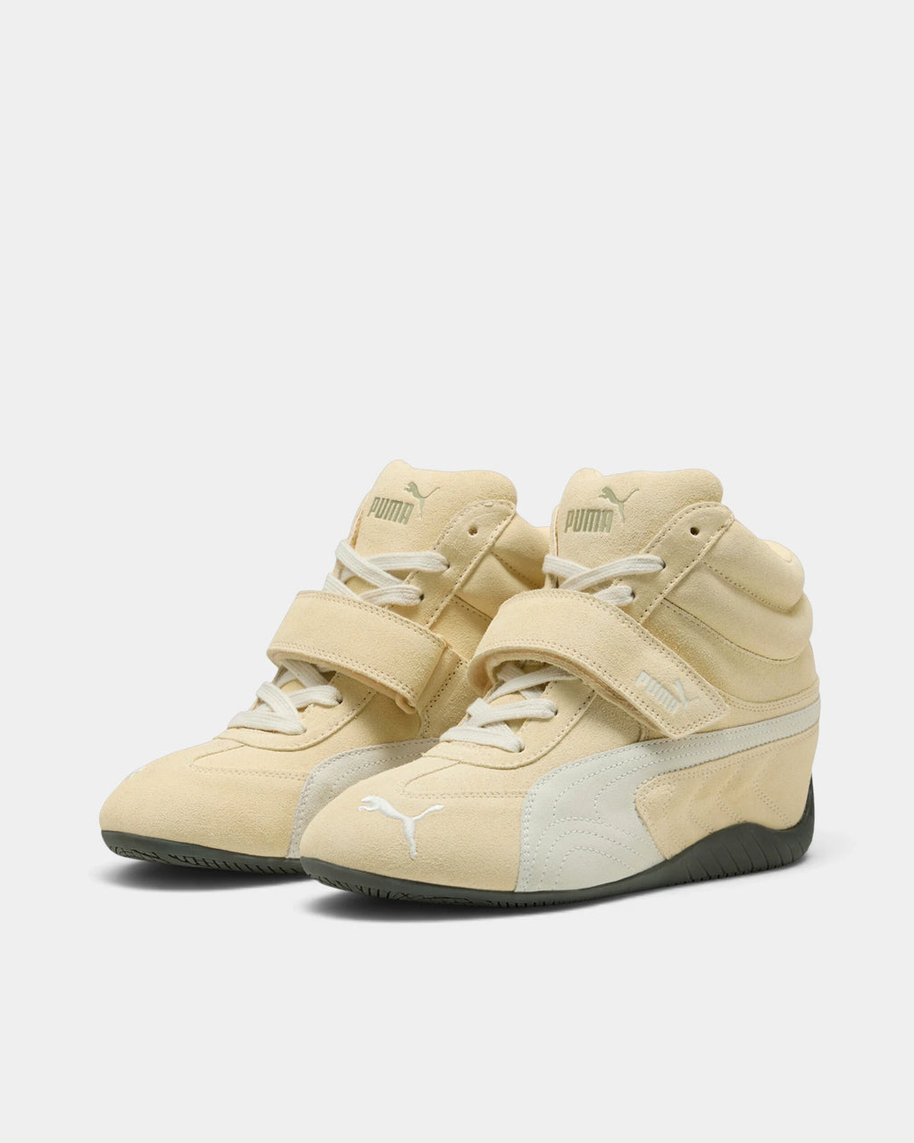 Puma Speedcat Wedge Shoes in Buttercream/Gum, both shoes from a three-quarter front angle, showing the cream suede upper with a white formstrip, hook-and-loop ankle strap and a dark gum sole