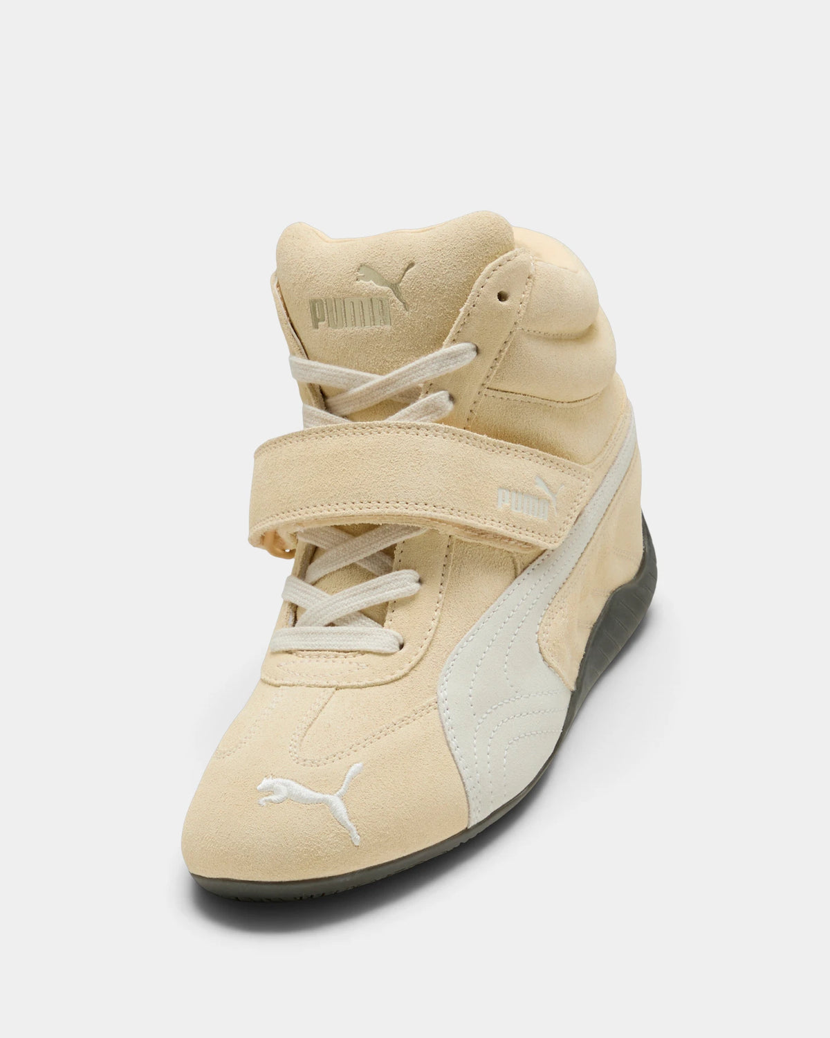 Puma Speedcat Wedge Shoes in Buttercream/Gum, right shoe from a raised three-quarter angle, showing the cream suede upper with a white formstrip, hook-and-loop ankle strap and a dark gum sole