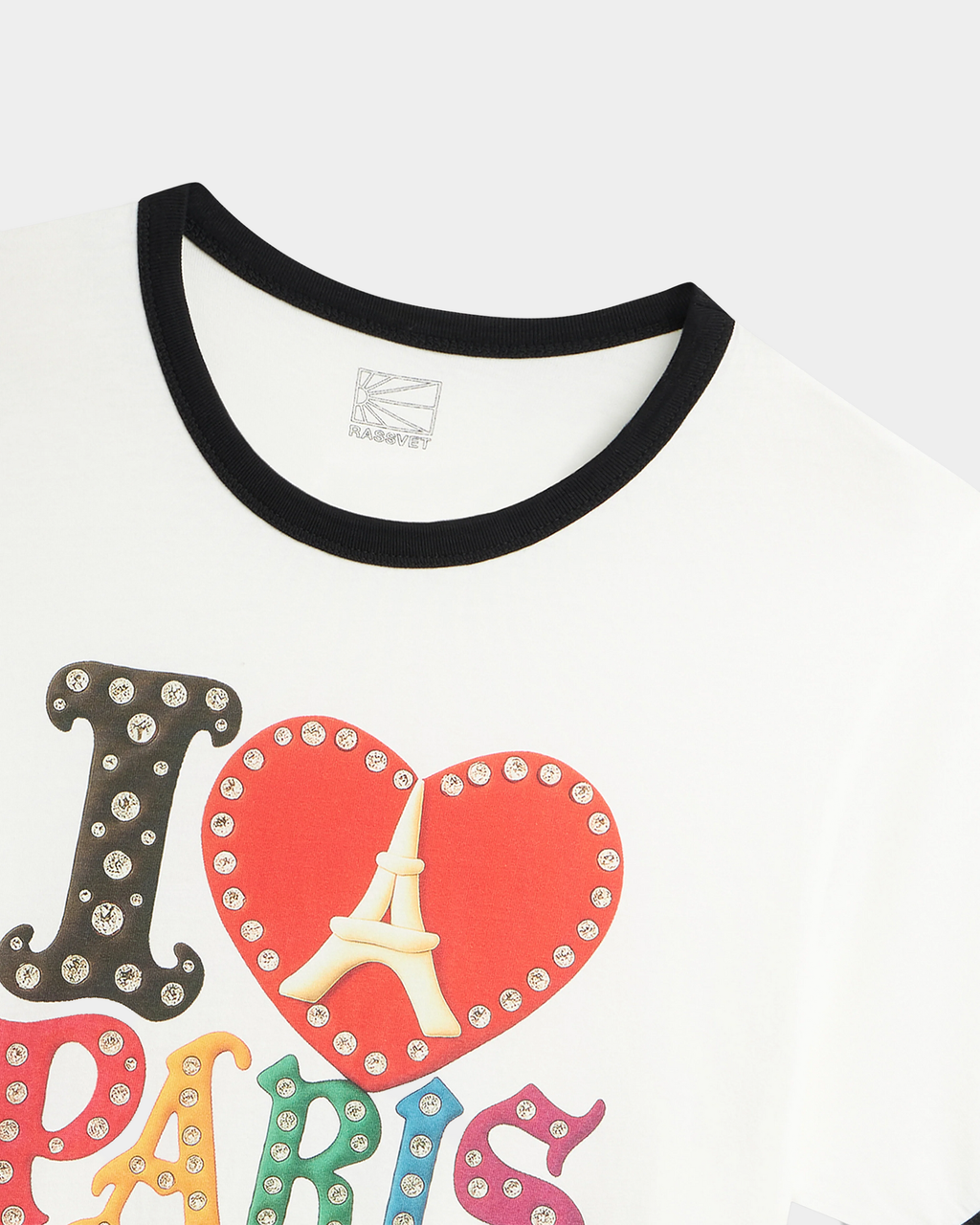Close-up of the Rassvet Jewel Ringer T-Shirt collar, showing the black ribbed ringer trim, the woven Rassvet neck label and the raised print letters studded with clear gems