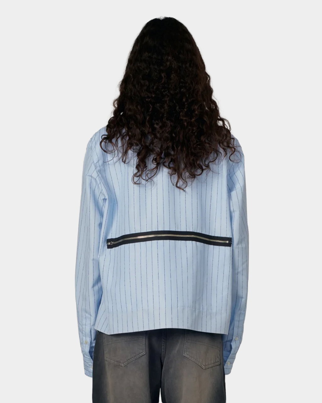 The same shirt from behind, showing the horizontal black zip pocket running across the back below the yoke
