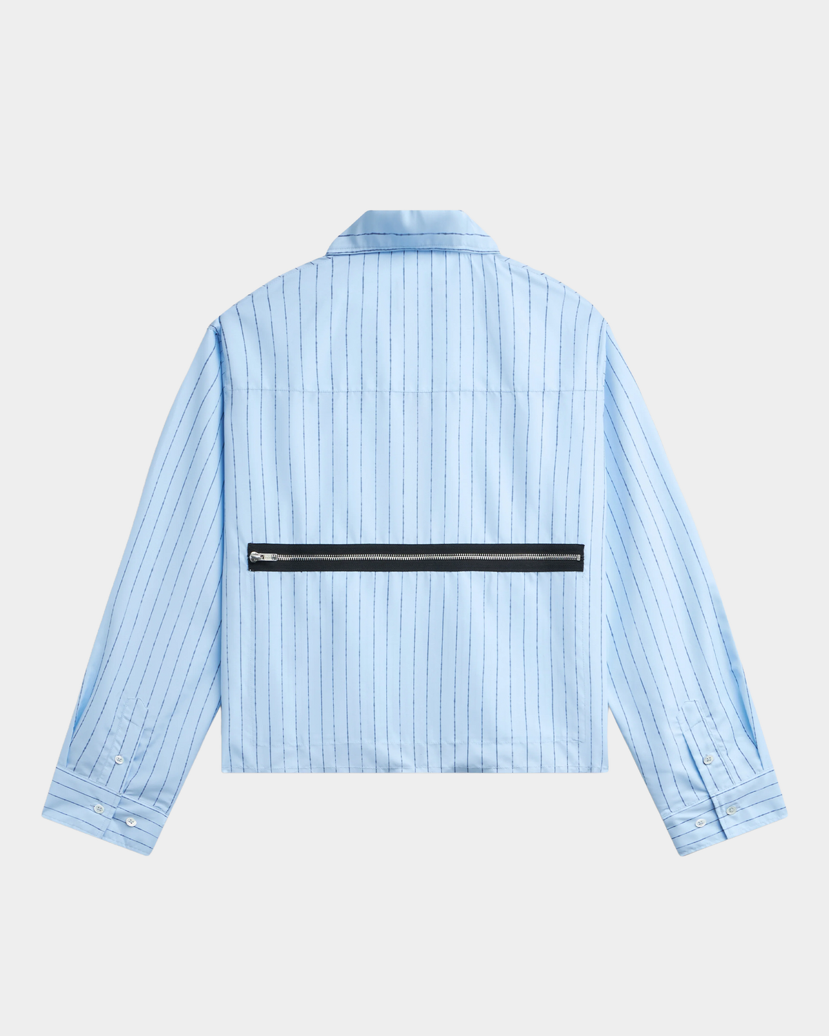 The back of the pale blue pinstripe Rassvet Striped Loose Zip Shirt laid flat, with the black zip pocket across the back and buttoned cuffs