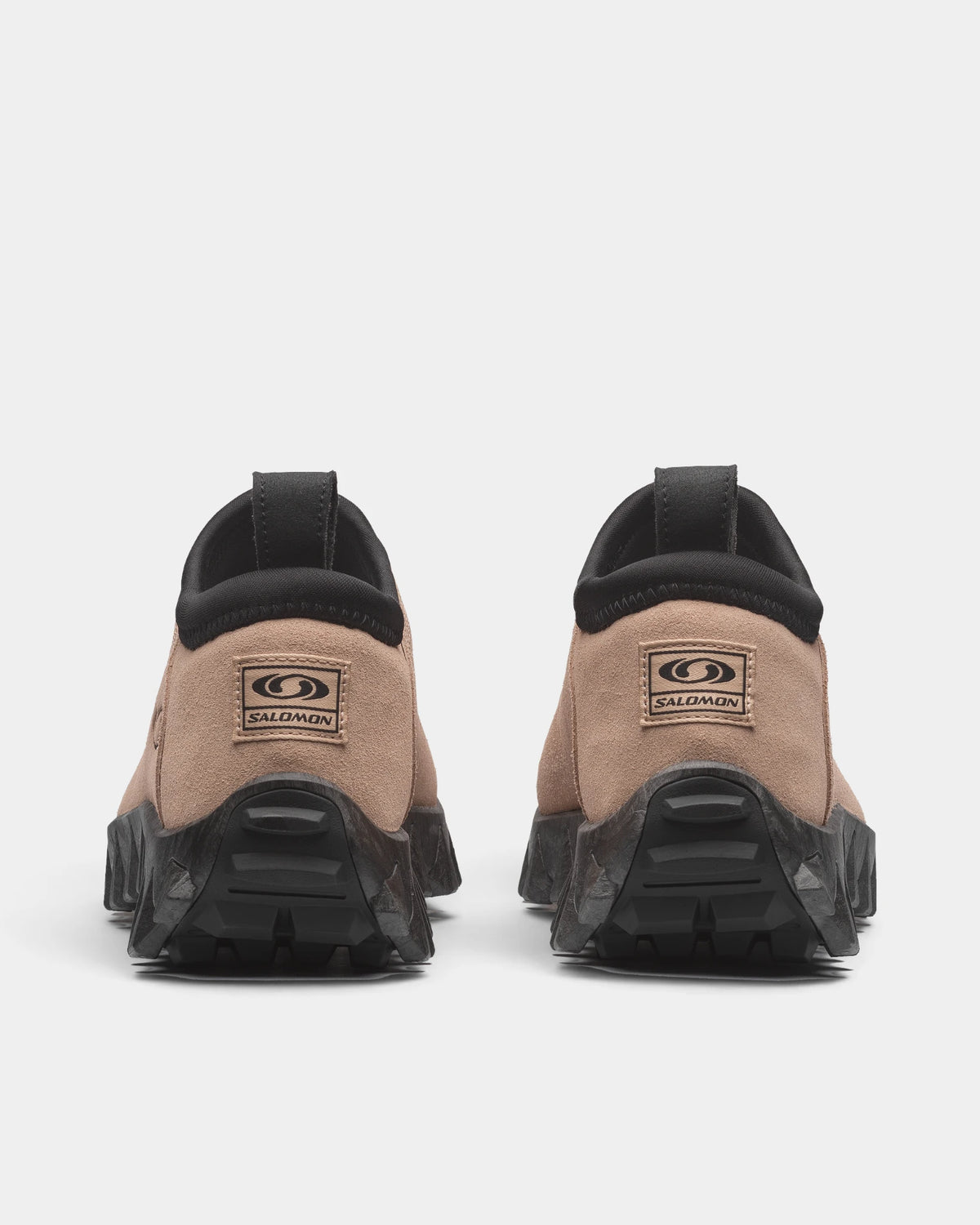 Salomon Snowclog OG Shoes in Safari/Black/Black, both shoes from behind, showing the sand-coloured slip-on upper with a black collar and a black lugged sole