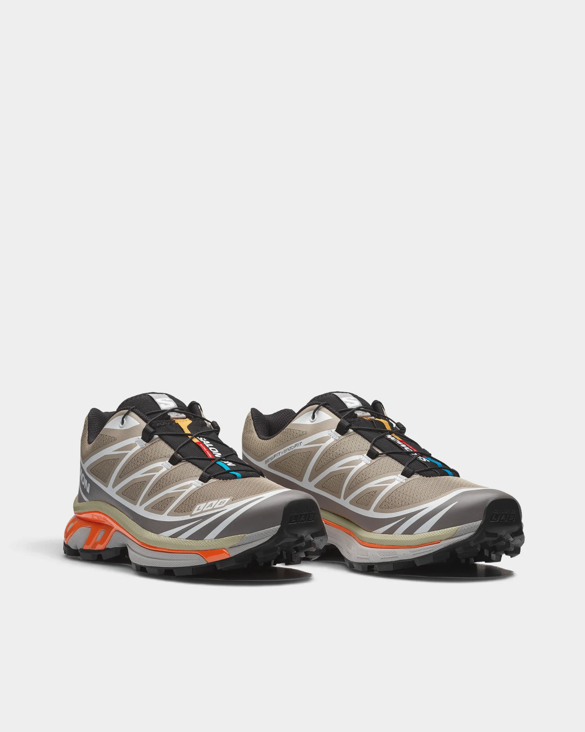 Salomon XT-6 Shoes in Silver Sage/Cloudburst/Dragon Fire, both shoes from a three-quarter front angle, showing the sand and silver mesh upper with white overlays on a grey and orange sole