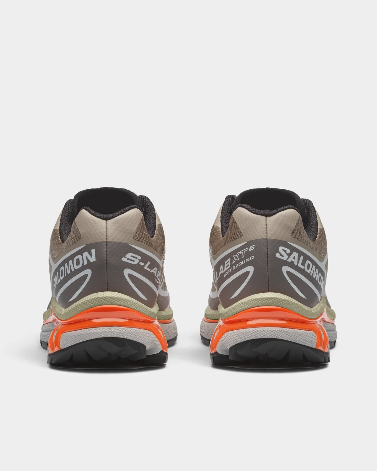 Salomon XT-6 Shoes in Silver Sage/Cloudburst/Dragon Fire, both shoes from behind, showing the sand and silver mesh upper with white overlays on a grey and orange sole