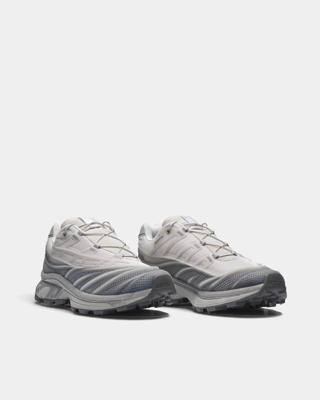 Salomon XT-EVO Shoes in Alloy/Castlerock/Footwear Silver, both shoes from a three-quarter front angle, showing the grey and silver layered upper on a grey sculpted sole