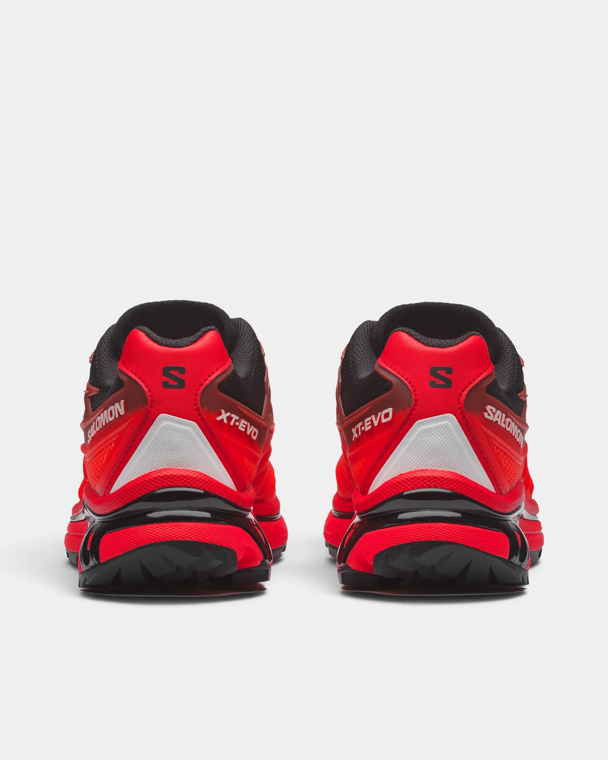 Salomon XT-EVO Shoes in Black/Fiery Red/White, both shoes from behind, showing the black and red layered upper on a red and black sculpted sole
