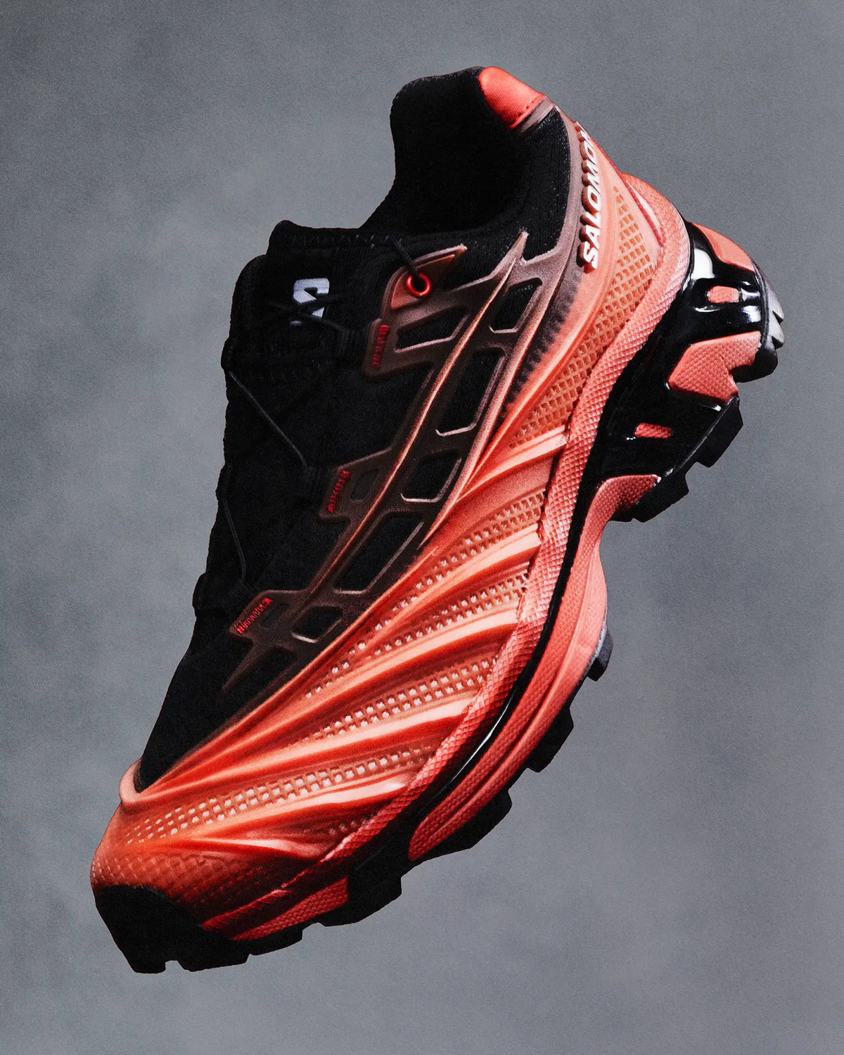 Salomon XT-EVO Shoes in Black/Fiery Red/White, single shoe at a three-quarter angle, suspended against a grey studio backdrop