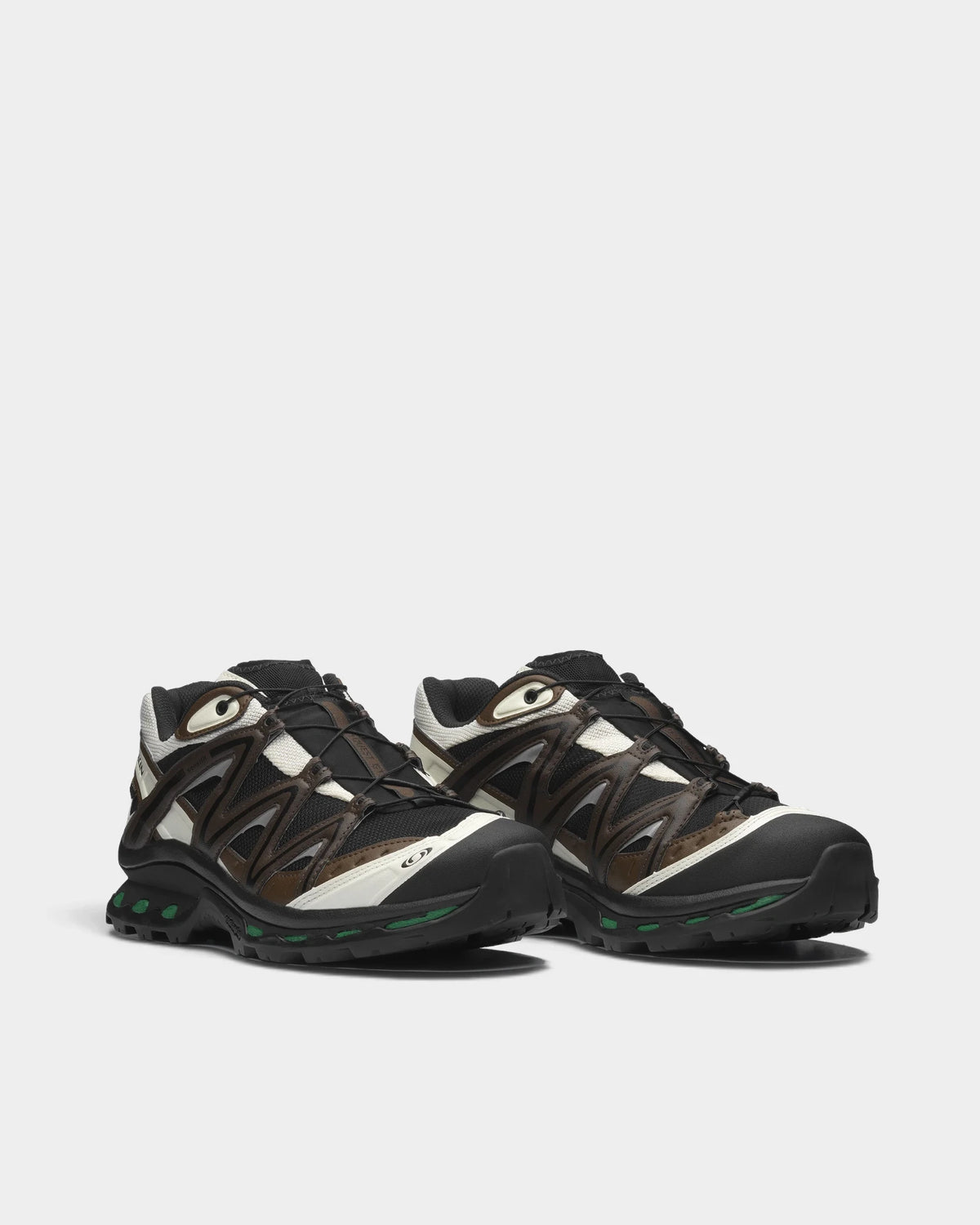 Salomon XT-Quest Gore-Tex Shoes in Black/Delicioso/Green Jacket, both shoes from a three-quarter front angle, showing the black and brown upper with off-white panels on a black sole with green accents