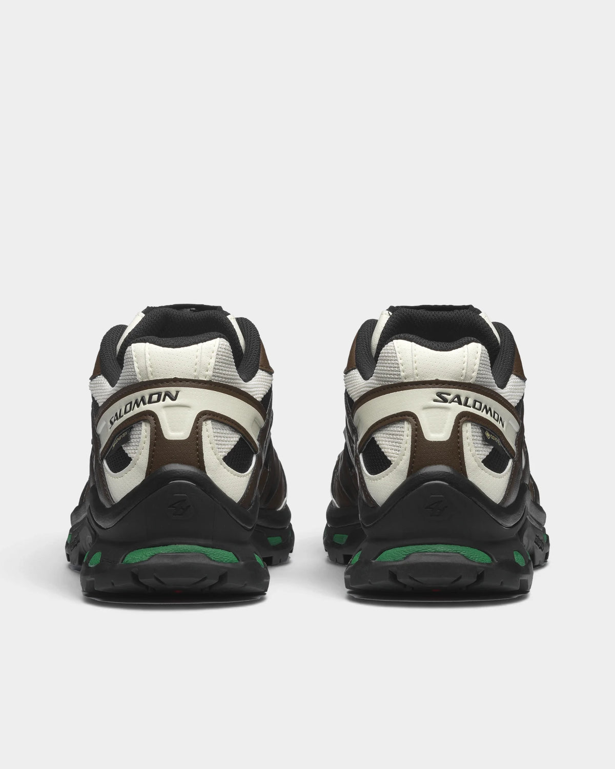 Salomon XT-Quest Gore-Tex Shoes in Black/Delicioso/Green Jacket, both shoes from behind, showing the black and brown upper with off-white panels on a black sole with green accents