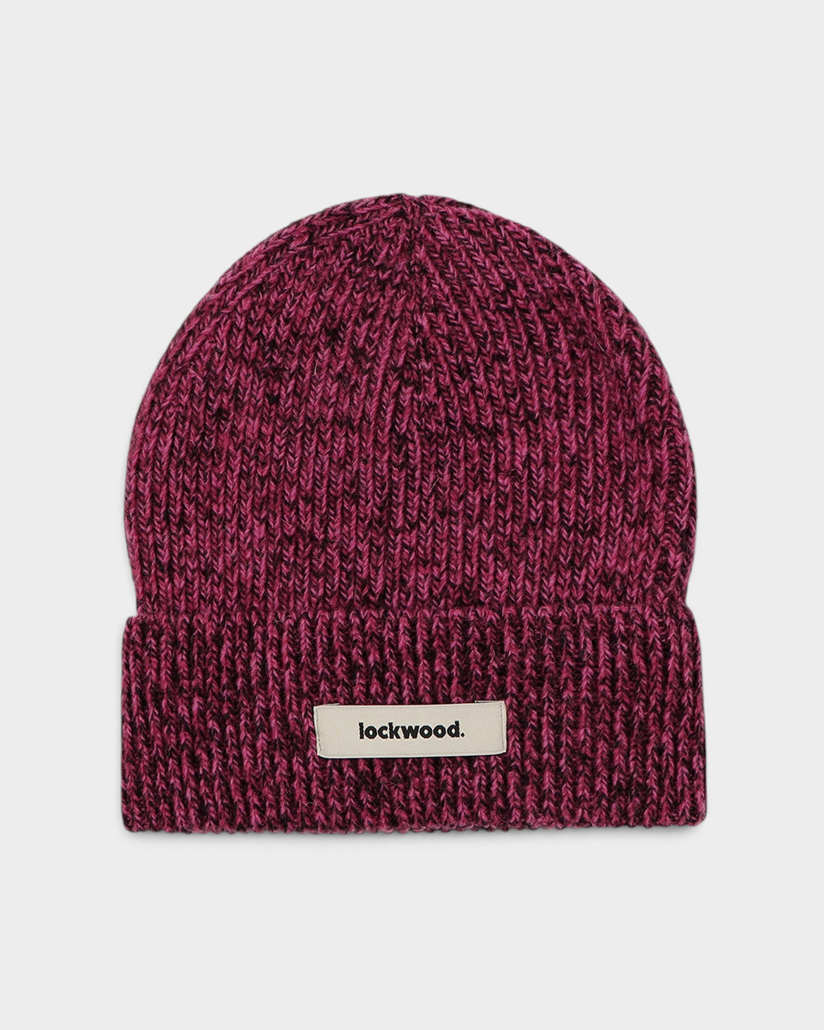 Lockwood Beanie in Pink: a berry pink marl rib knit flecked with dark yarn, with a folded cuff and a woven lockwood label
