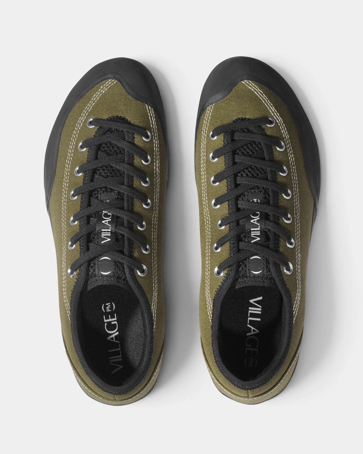 Village PM 1.30PM Canvas Shoes in Olive/Natural Black: the pair seen from directly above, toes up, showing the lacing and the tongue. A olive canvas low-top skate shoe on a natural black gum outsole.