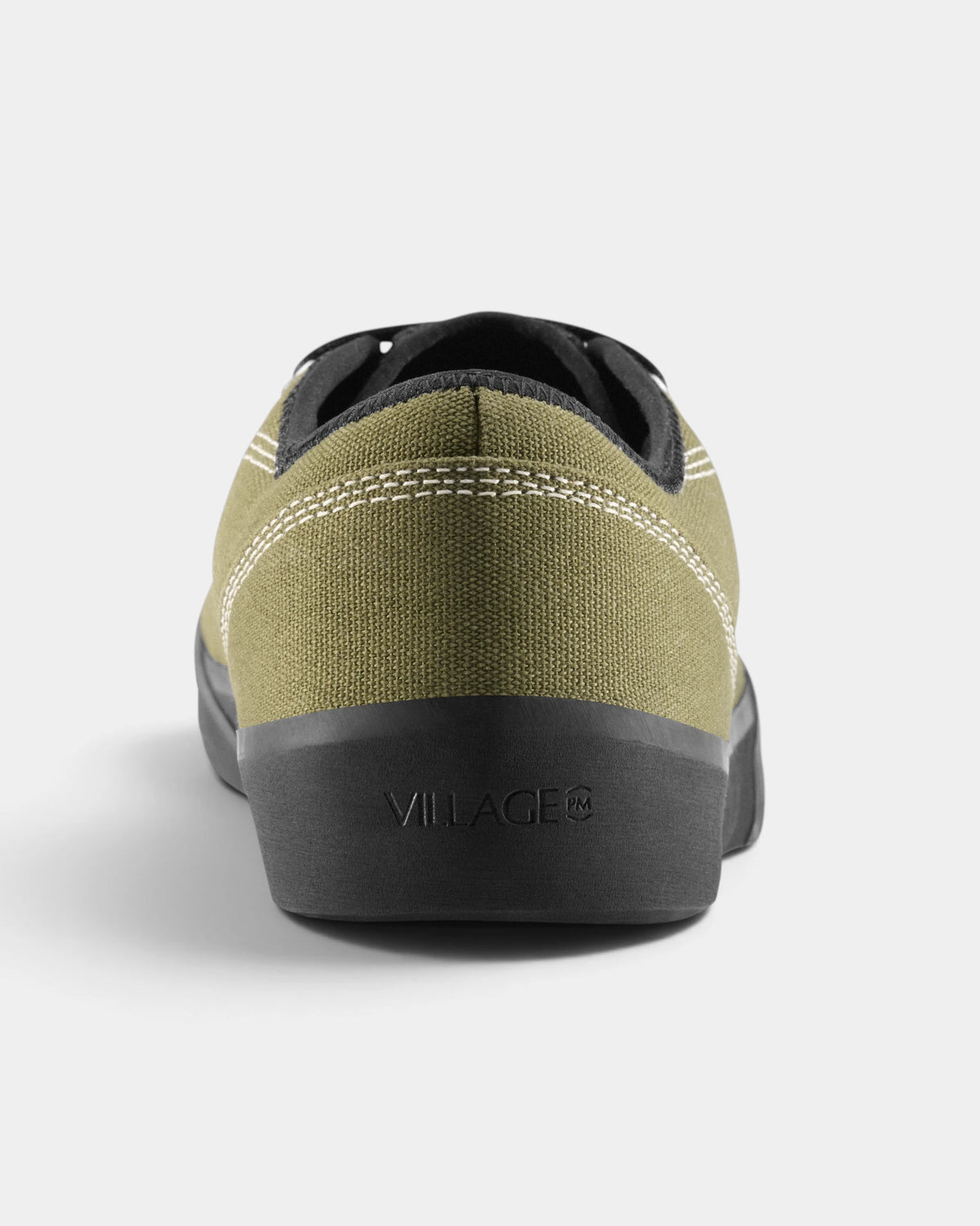 Village PM 1.30PM Canvas Shoes in Olive/Natural Black: a single shoe seen straight on from behind, showing the heel counter and collar. A olive canvas low-top skate shoe on a natural black gum outsole.