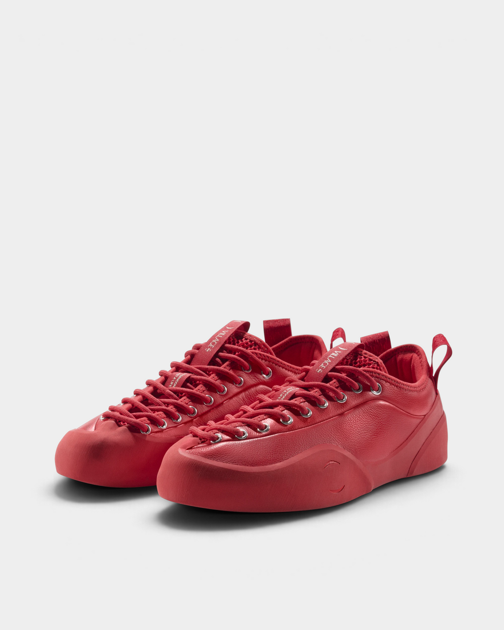 Village PM 1PM Full Grain Leather Shoes in Red: an all red full grain leather low-top skate shoe with red laces and a red sole, the pair seen at an angle from the front