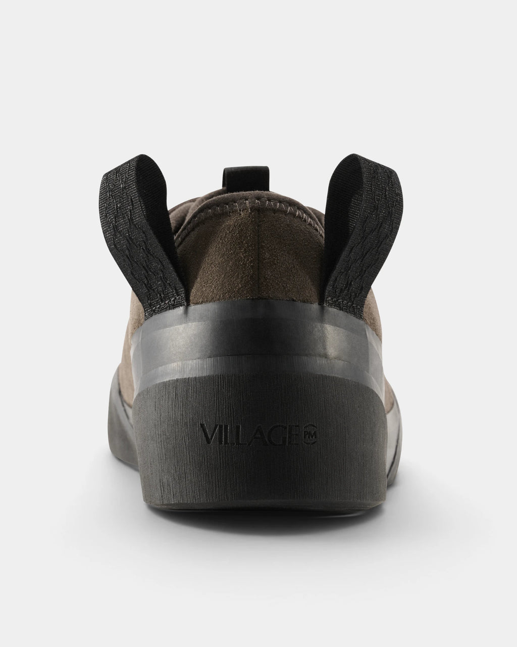 Village PM 1PM Leather Suede Shoes in Chocolate/Natural Black: a single shoe seen straight on from behind, showing the heel counter and collar. A chocolate brown suede low-top skate shoe on a natural black gum outsole.