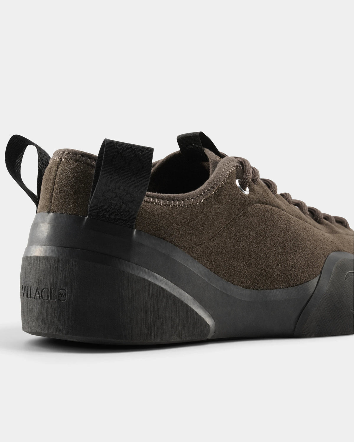 Village PM 1PM Leather Suede Shoes in Chocolate/Natural Black: a close three-quarter view of the heel and the outer side. A chocolate brown suede low-top skate shoe on a natural black gum outsole.